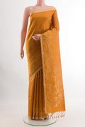 Yellow Soft Silk Saree with Zari Butta on the body and Zari Border.  displayed on a mannequin