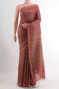 Brick Orange Tussar Saree with Printed design on the body and Zari Border.  displayed on a mannequin