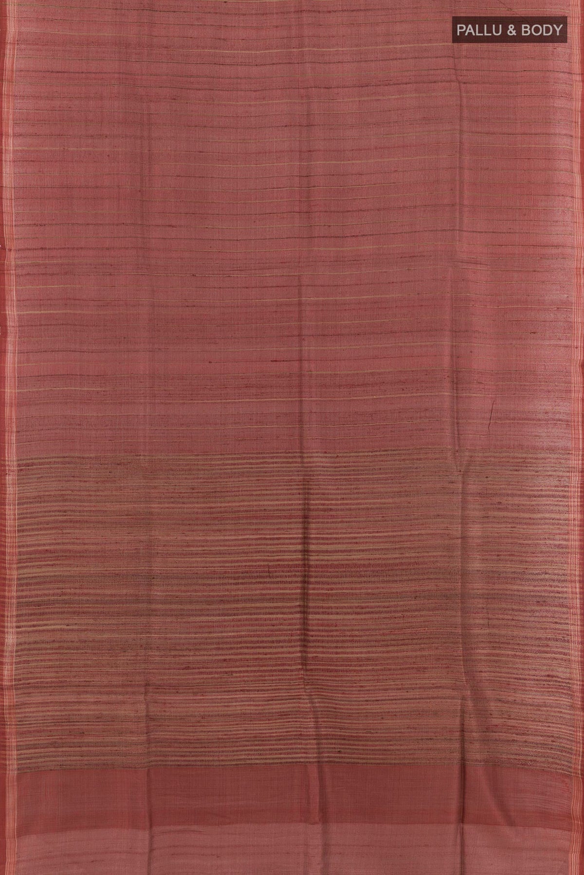 Flat view of Brick Orange Tussar Saree with Printed design on the body and Zari Border. 