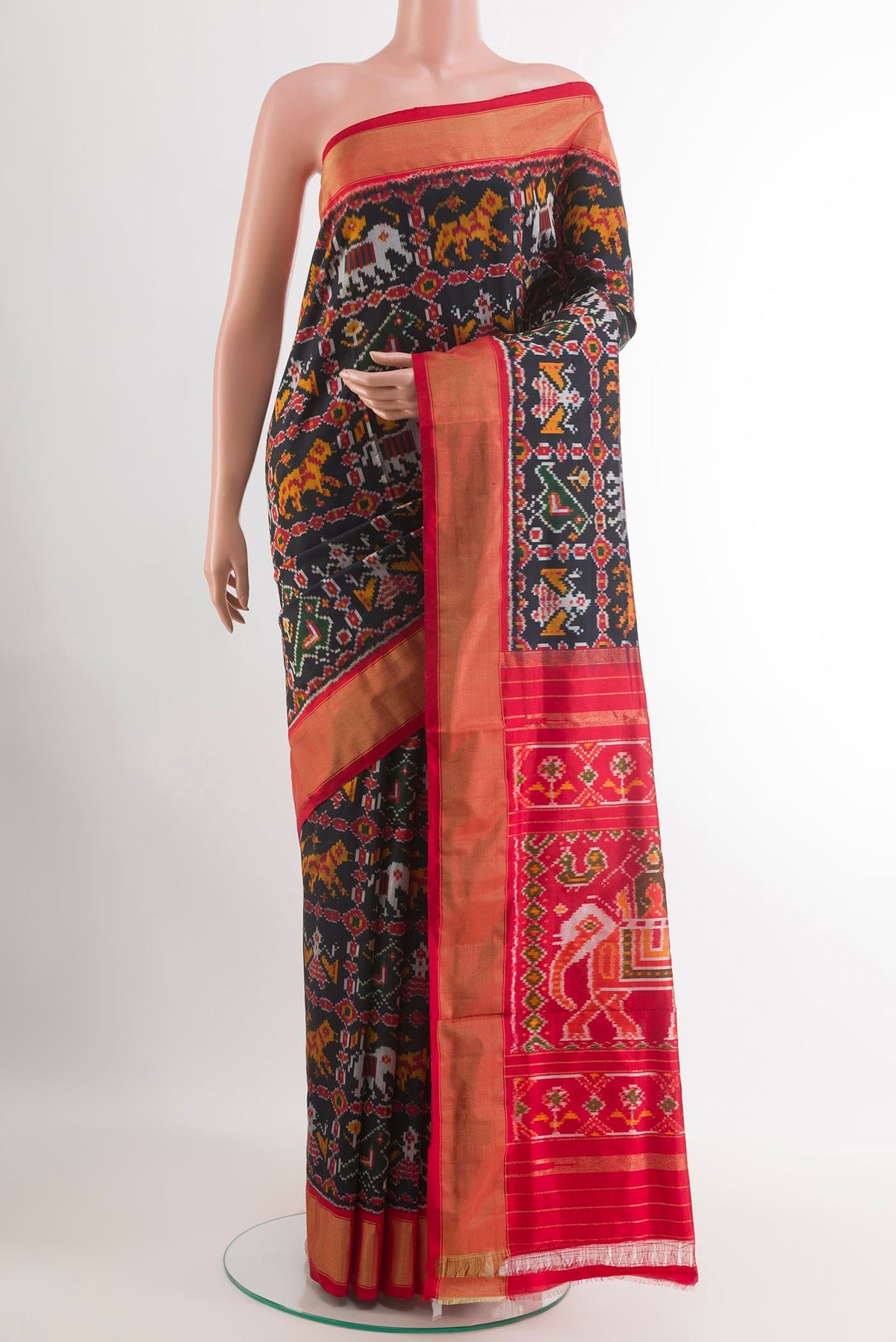 Black Pochampally Silk Saree with Pure Ikat on the body and Zari Border.  displayed on a mannequin