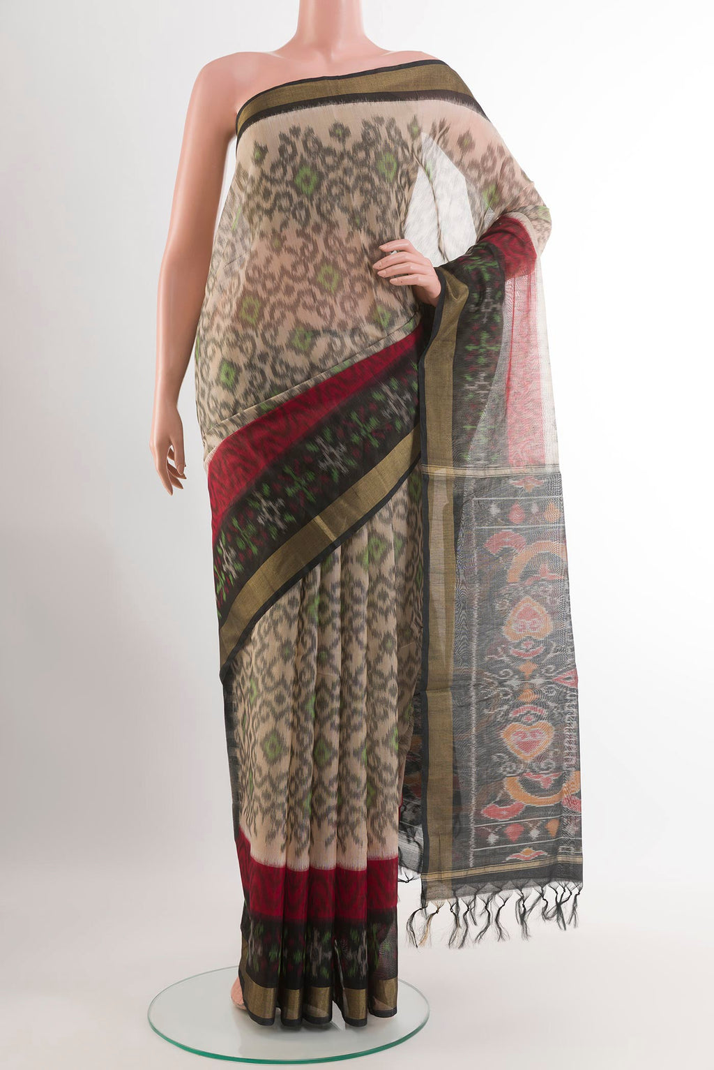 Beige Kora Cotton Saree with Ikat design on the body and Zari Border.  displayed on a mannequin