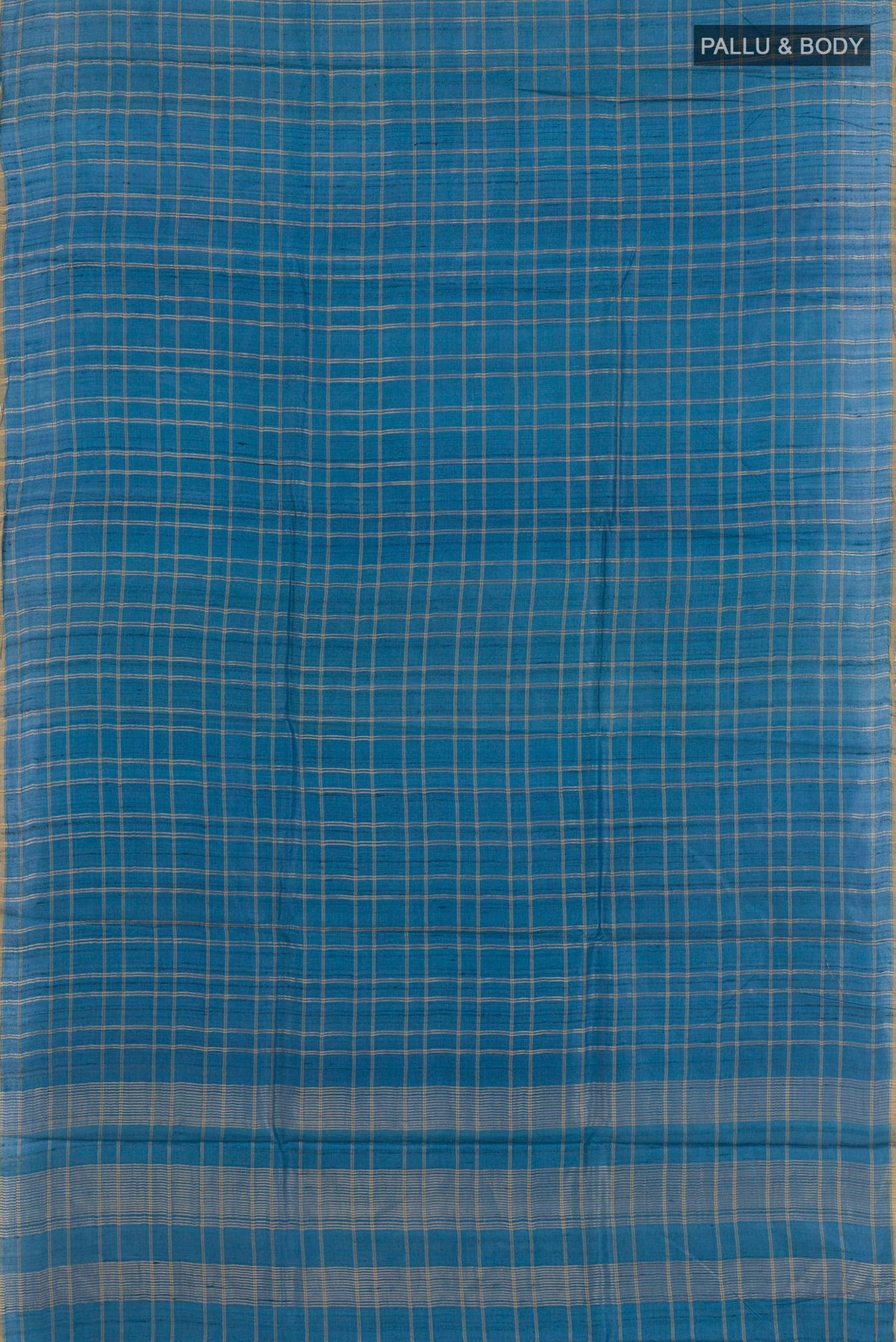Flat view of Blue Tussar Saree with Checked design on the body and Zari Border. 