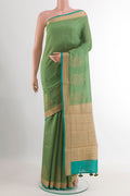 Green Tussar Saree with Zari Butta on the body and Zari Border.  displayed on a mannequin