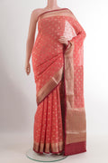 Coral Linen Saree with Zari Butta on the body and Zari Border.  displayed on a mannequin
