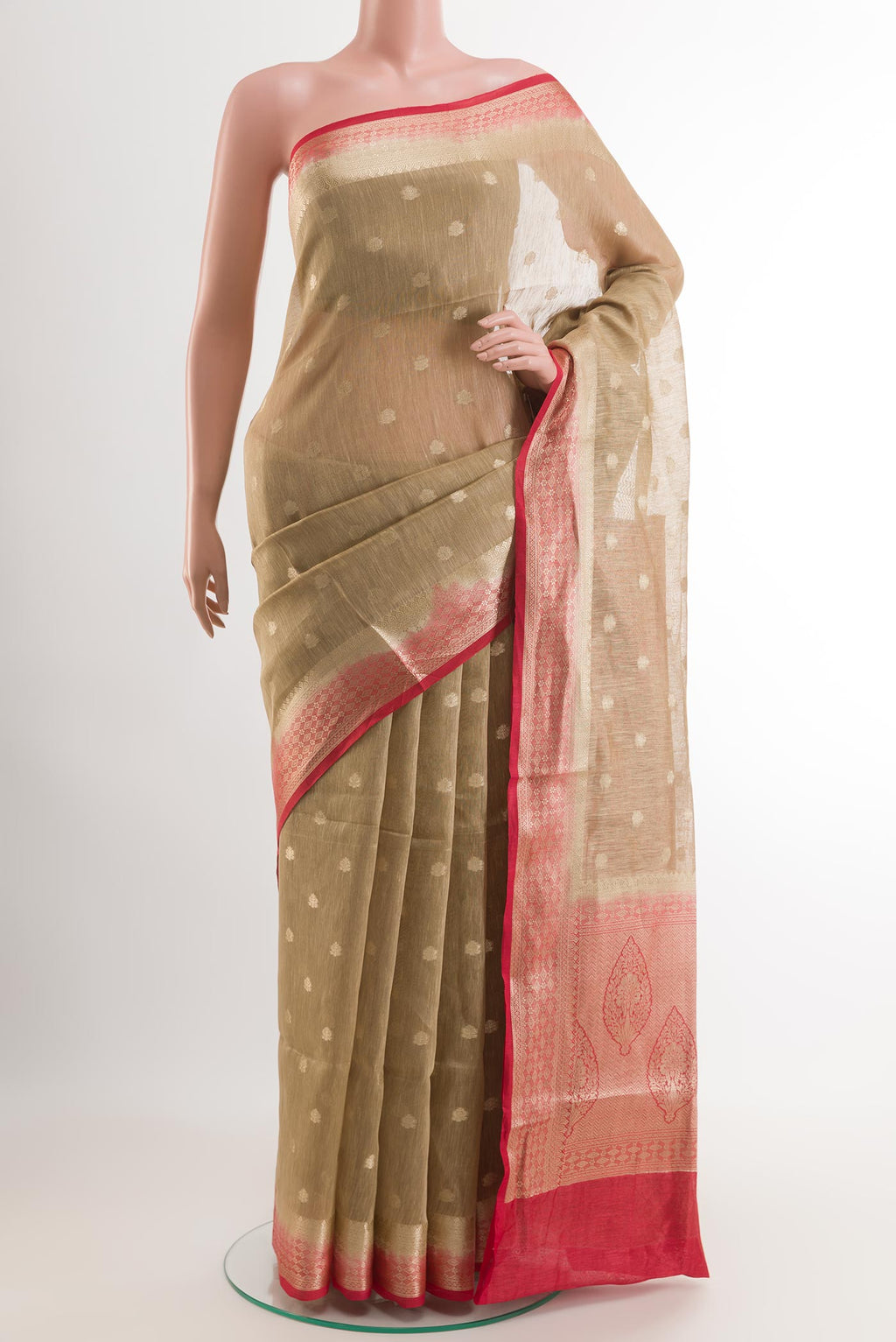 Beige Linen Saree with Zari Butta on the body and Zari Border.  displayed on a mannequin