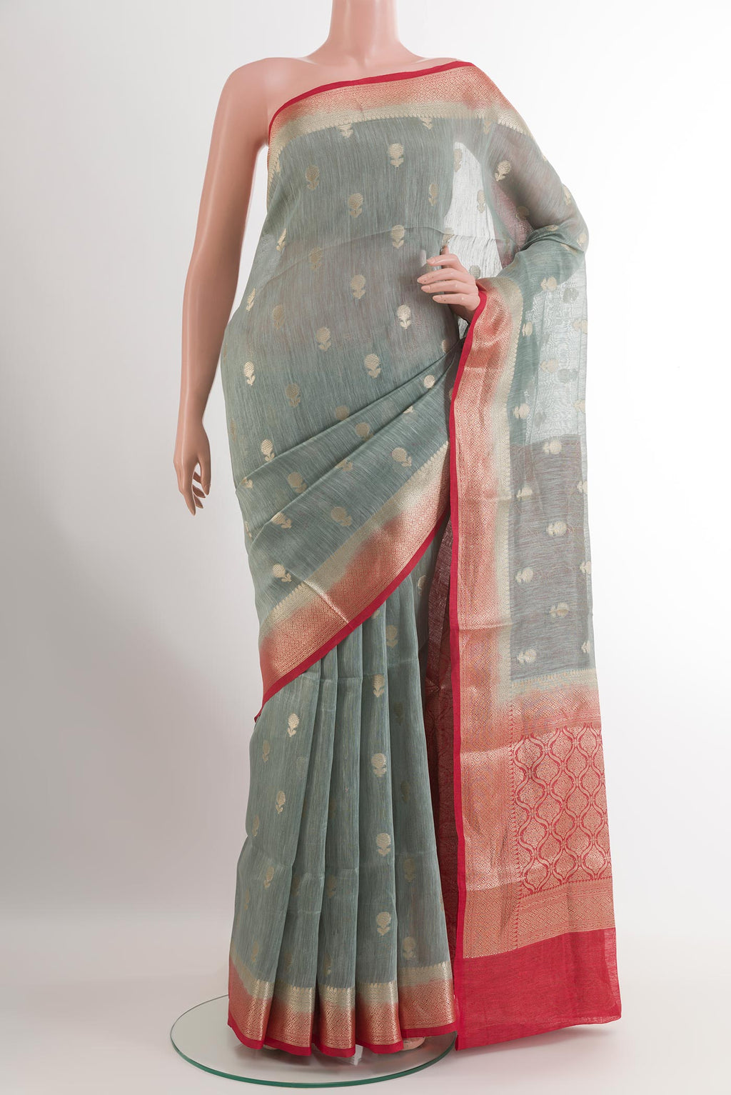 Grey Linen Saree with Zari Butta on the body and Zari Border.  displayed on a mannequin