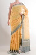 Yellow Linen Saree with Zari Butta on the body and Zari Border.  displayed on a mannequin