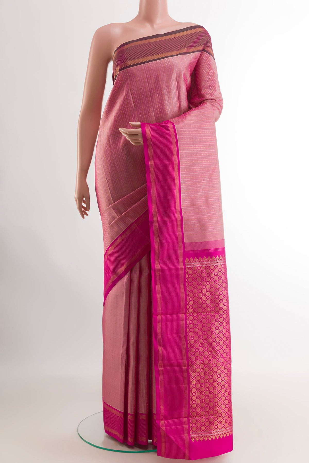 Pink Kanjivaram Silk Saree with Stripes on the body and Zari Border.  displayed on a mannequin