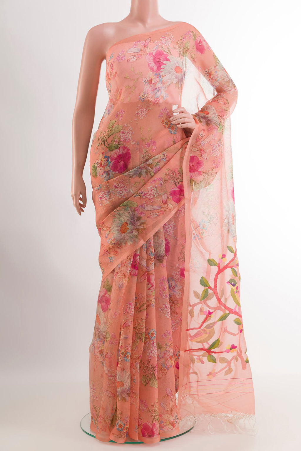 Peach Organza Silk Saree with Floral Print on the body and Without Border.  displayed on a mannequin