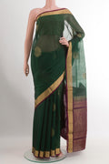 Green Blended Kora Cotton Saree with Zari Butta on the body and Zari Border.  displayed on a mannequin