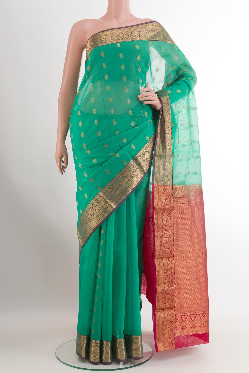 Turquoise Silk Cotton Saree with Zari Butta on the body and Zari Border.  displayed on a mannequin