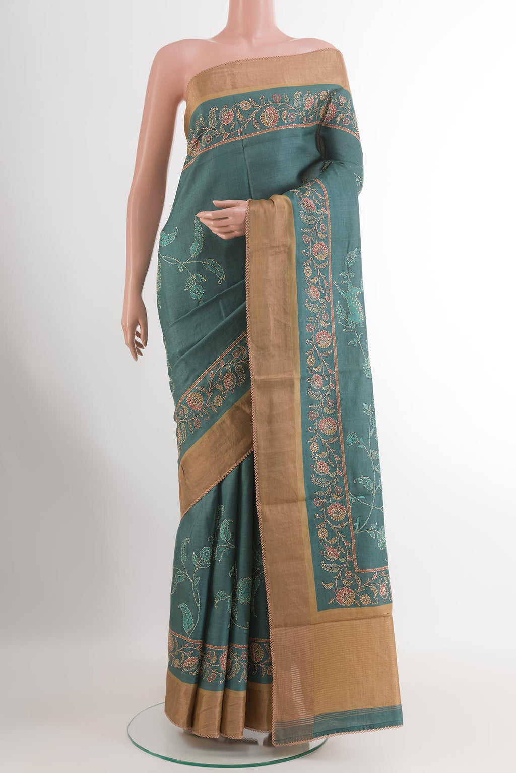 Blue Grey Tussar Silk Saree with Embroidery on the body and Zari Border.  displayed on a mannequin