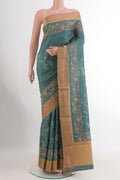 Blue Grey Tussar Silk Saree with Embroidery on the body and Zari Border.  displayed on a mannequin