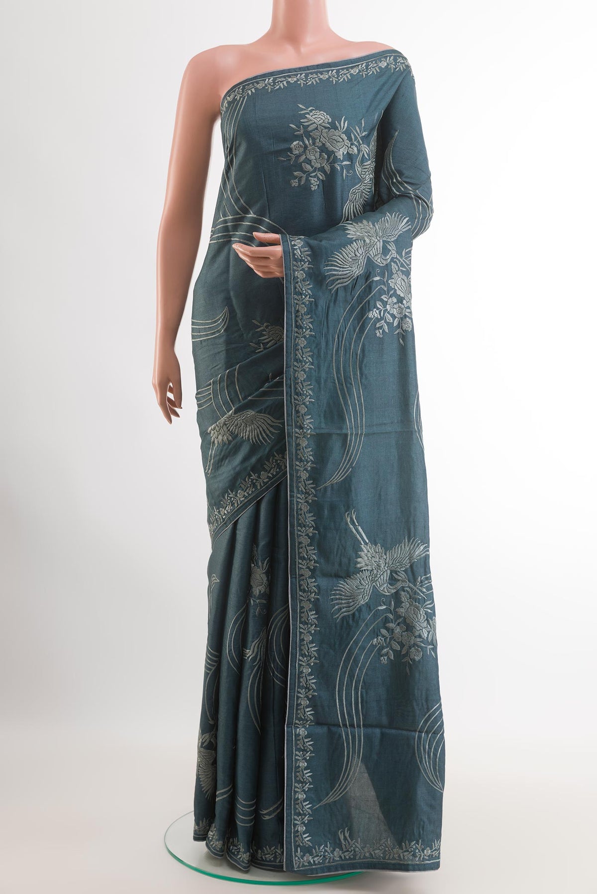 Blue Tussar Silk Saree with Embroidery on the body and Embroidery Border.  displayed on a mannequin