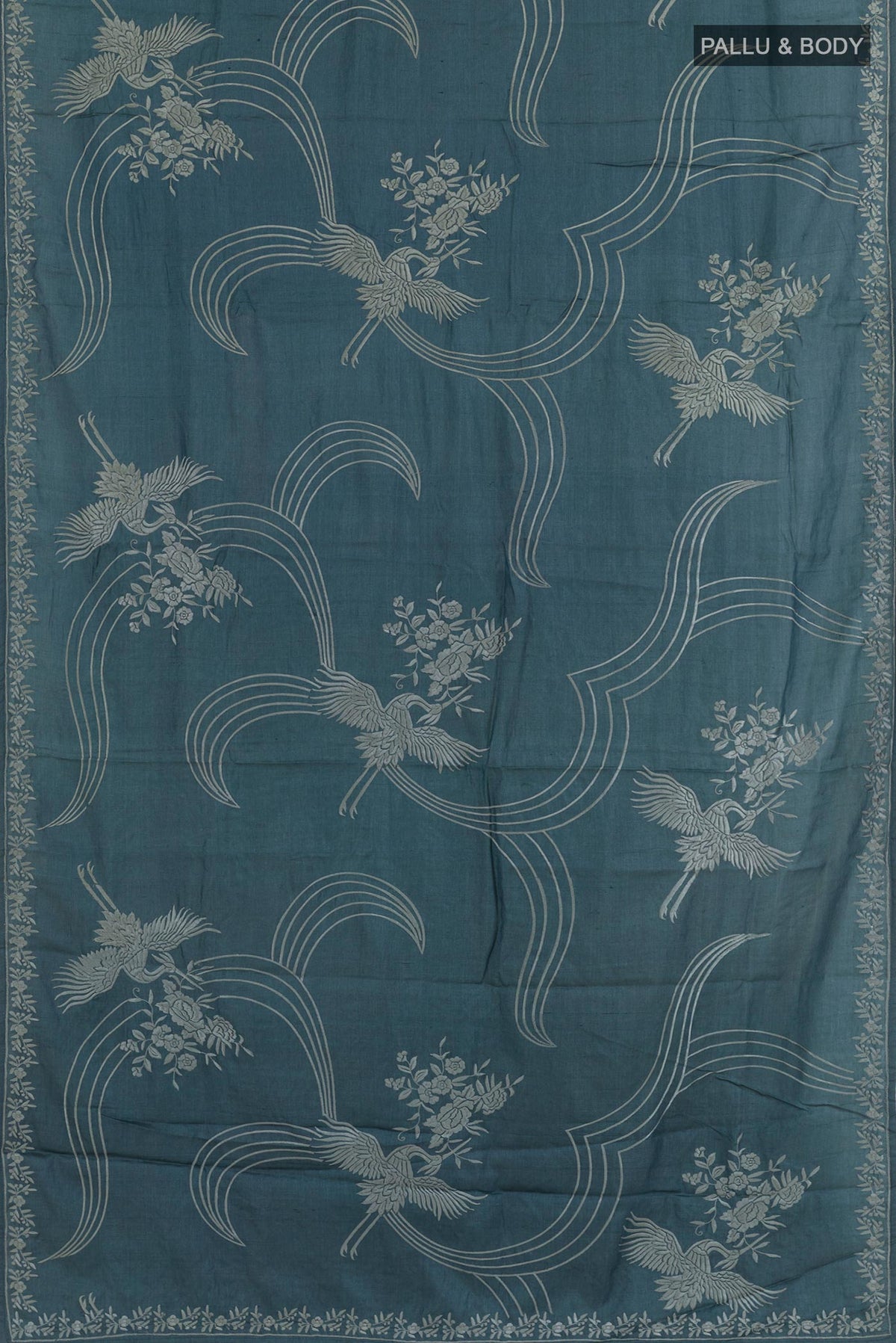 Flat view of Blue Tussar Silk Saree with Embroidery on the body and Embroidery Border. 
