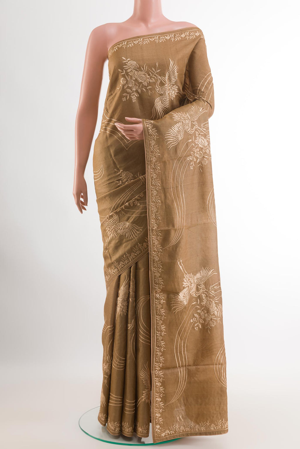 Brown Tussar Silk Saree with Embroidery on the body and Embroidery Border.  displayed on a mannequin