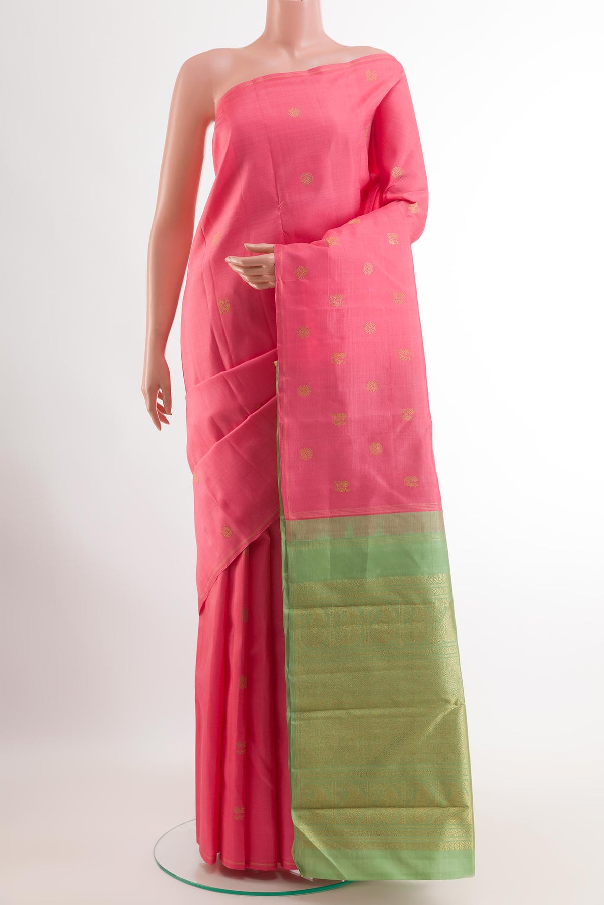 Pure Silk Pure Zari Coral Kanchipuram Saree with Zari Butta on the body and Without Border.  displayed on a mannequin