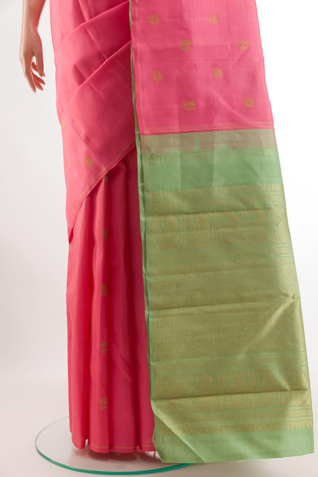 Pleats and pallu of Pure Silk Pure Zari Coral Kanchipuram Saree with Zari Butta on the body and Without Border. 