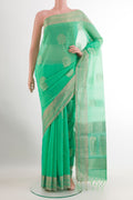 Turquoise Silk Cotton Saree with Zari Butta on the body and Zari Border.  displayed on a mannequin