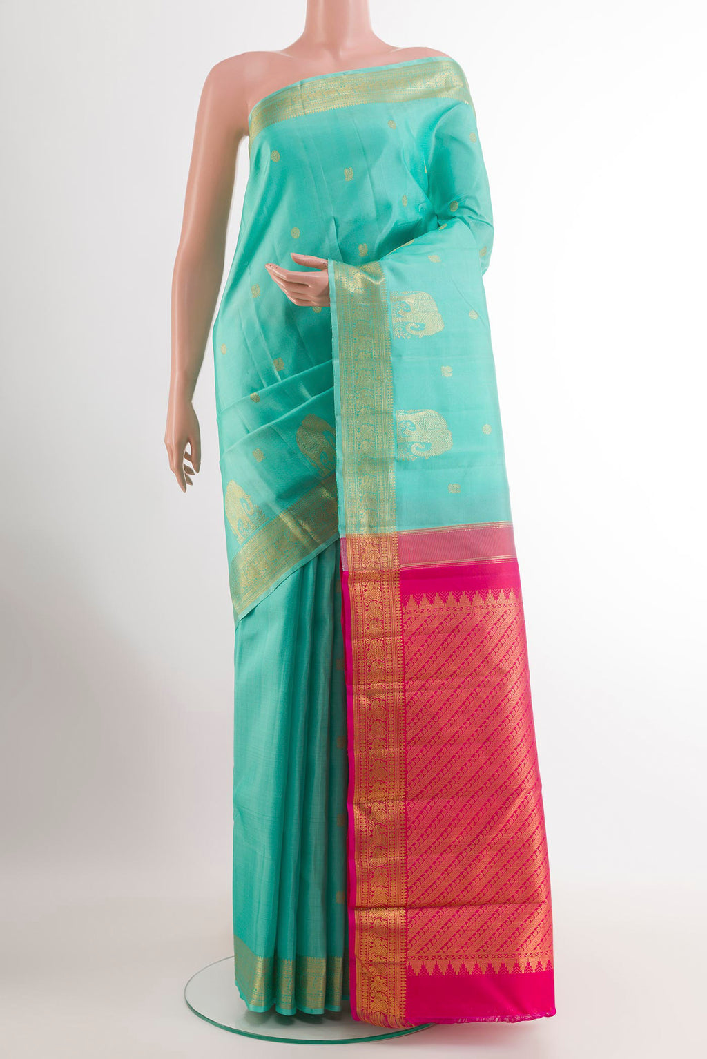 Turquoise Kanjivaram Silk Saree with Zari Butta on the body and Zari Border.  displayed on a mannequin