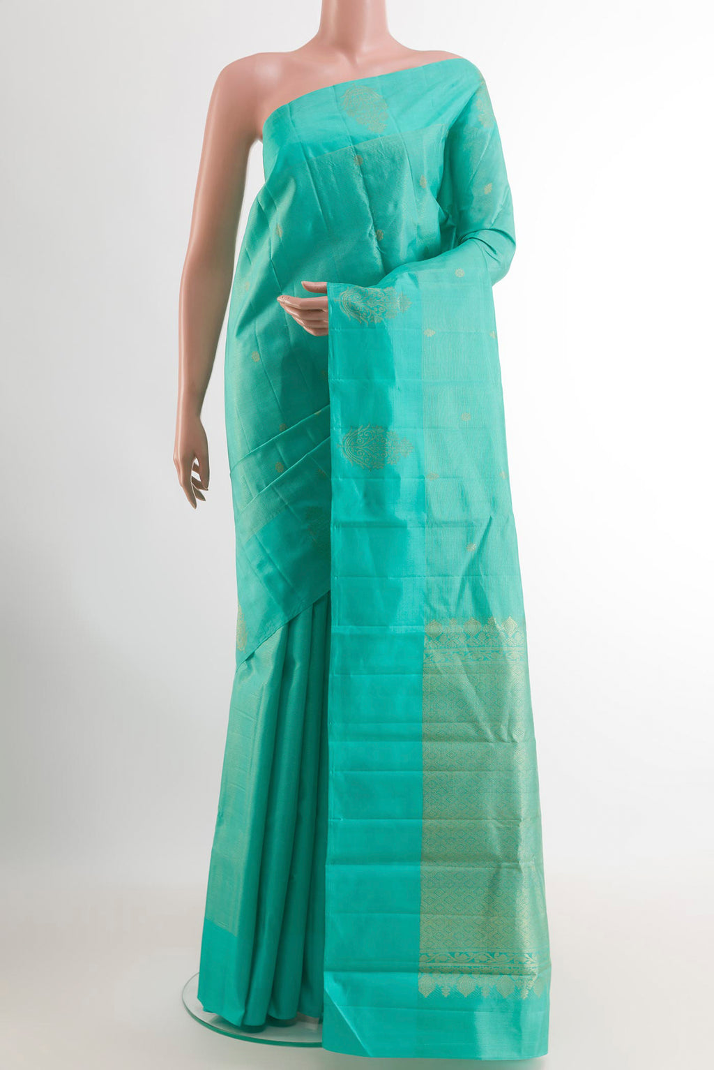 Turquoise Kanchipuram Silk Saree with Zari Butta on the body and Zari Border.  displayed on a mannequin