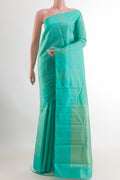 Turquoise Kanchipuram Silk Saree with Zari Butta on the body and Zari Border.  displayed on a mannequin