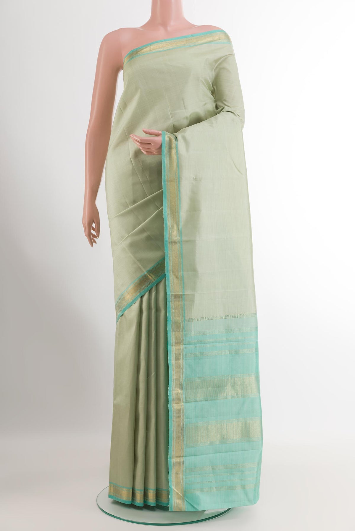 Mint Green Kanjivaram Silk Saree with Plain Body and Zari Border.  displayed on a mannequin