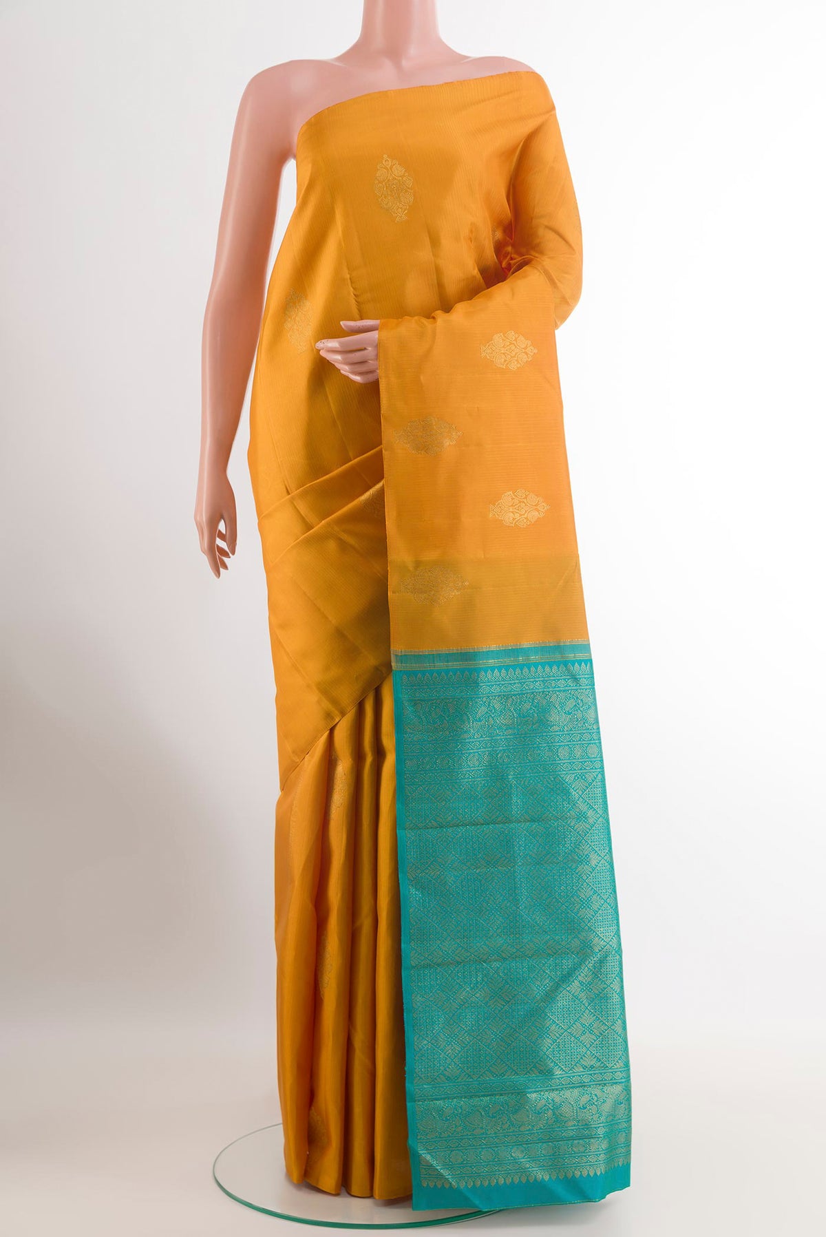 Yellow Kanchipuram Silk Saree with Zari Butta on the body and Without Border.  displayed on a mannequin