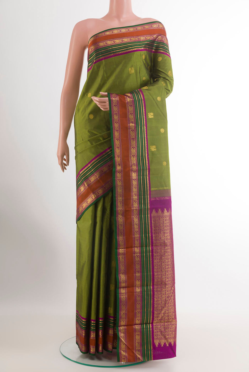 Mehandi Green Kanchipuram Silk Saree with Zari Butta on the body and Zari Border.  displayed on a mannequin
