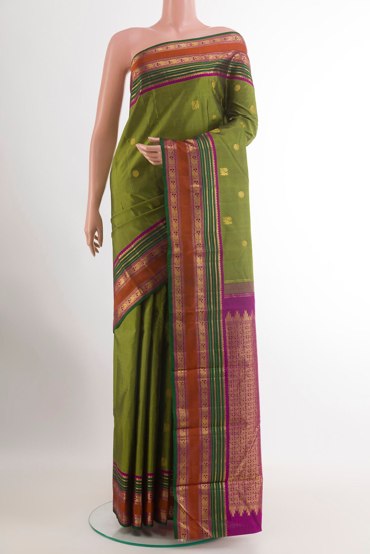 Mehandi Green Kanchipuram Silk Saree with Zari Butta on the body and Zari Border.  displayed on a mannequin