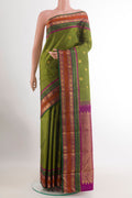 Green Kanchipuram Silk Saree with Zari Butta on the body and Zari Border.  displayed on a mannequin