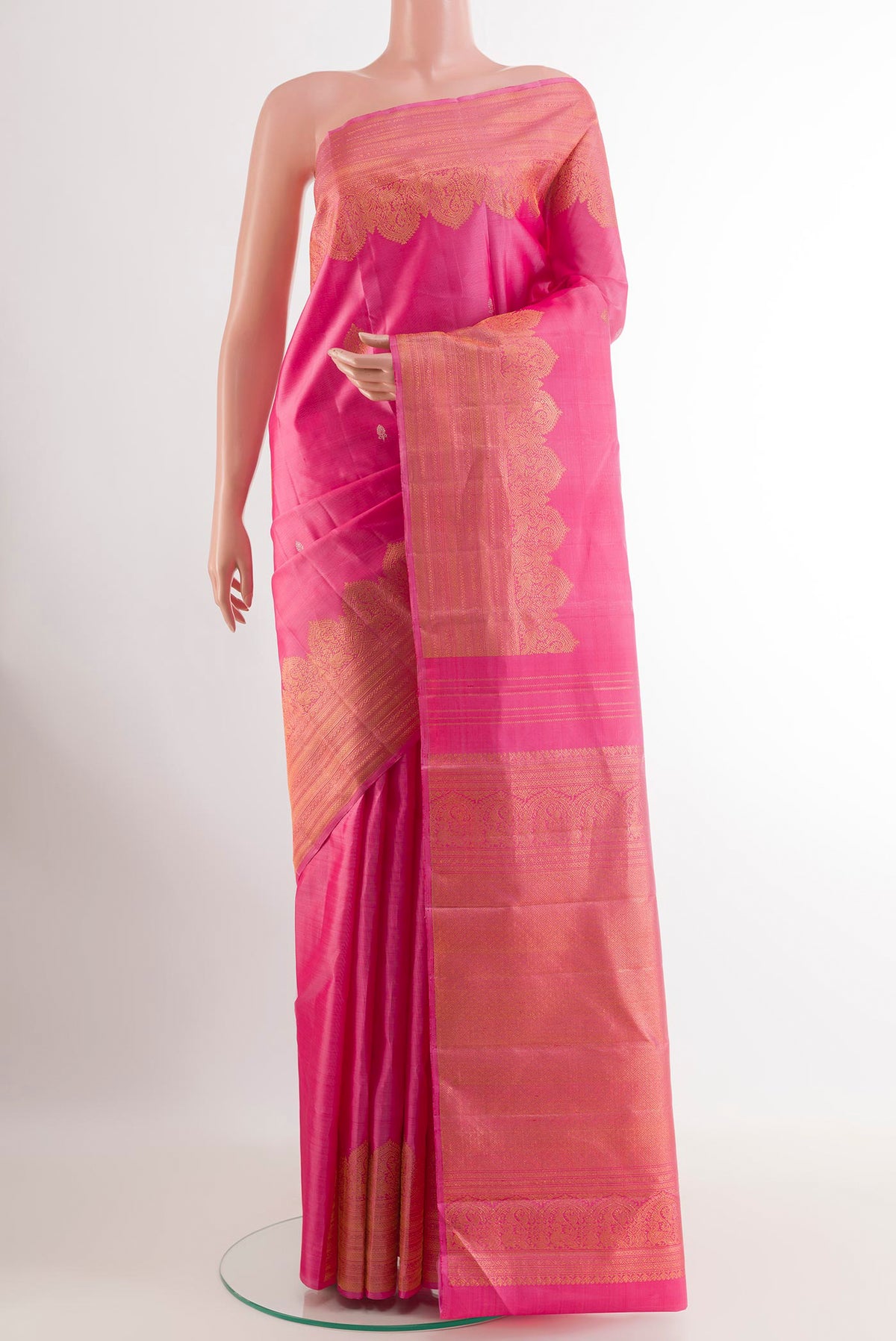 Pink Kanjivaram Silk Saree with Zari Butta on the body and Fancy Border.  displayed on a mannequin