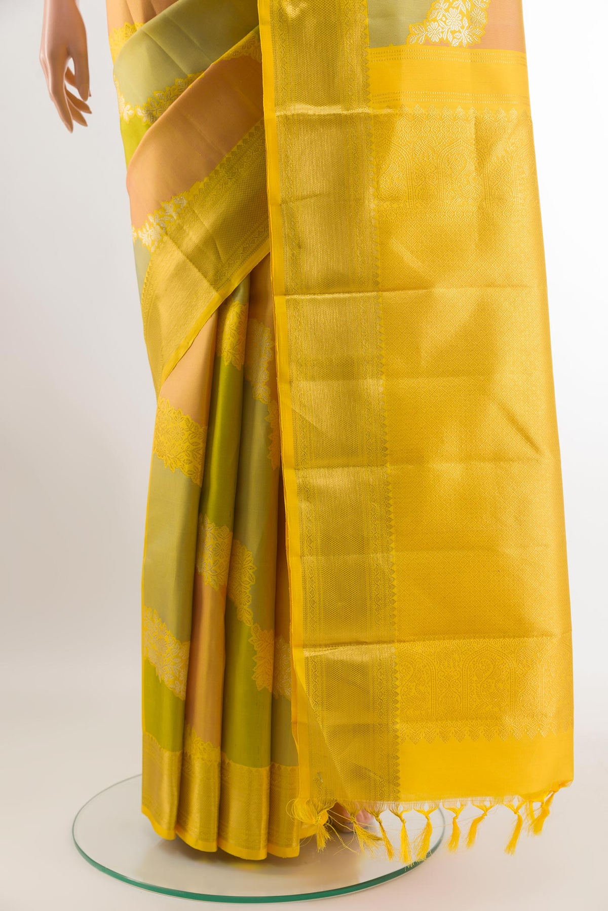 Pleats and pallu of Yellow Kanchipuram Silk Saree with Zari Brocade on the body and Zari Border. 