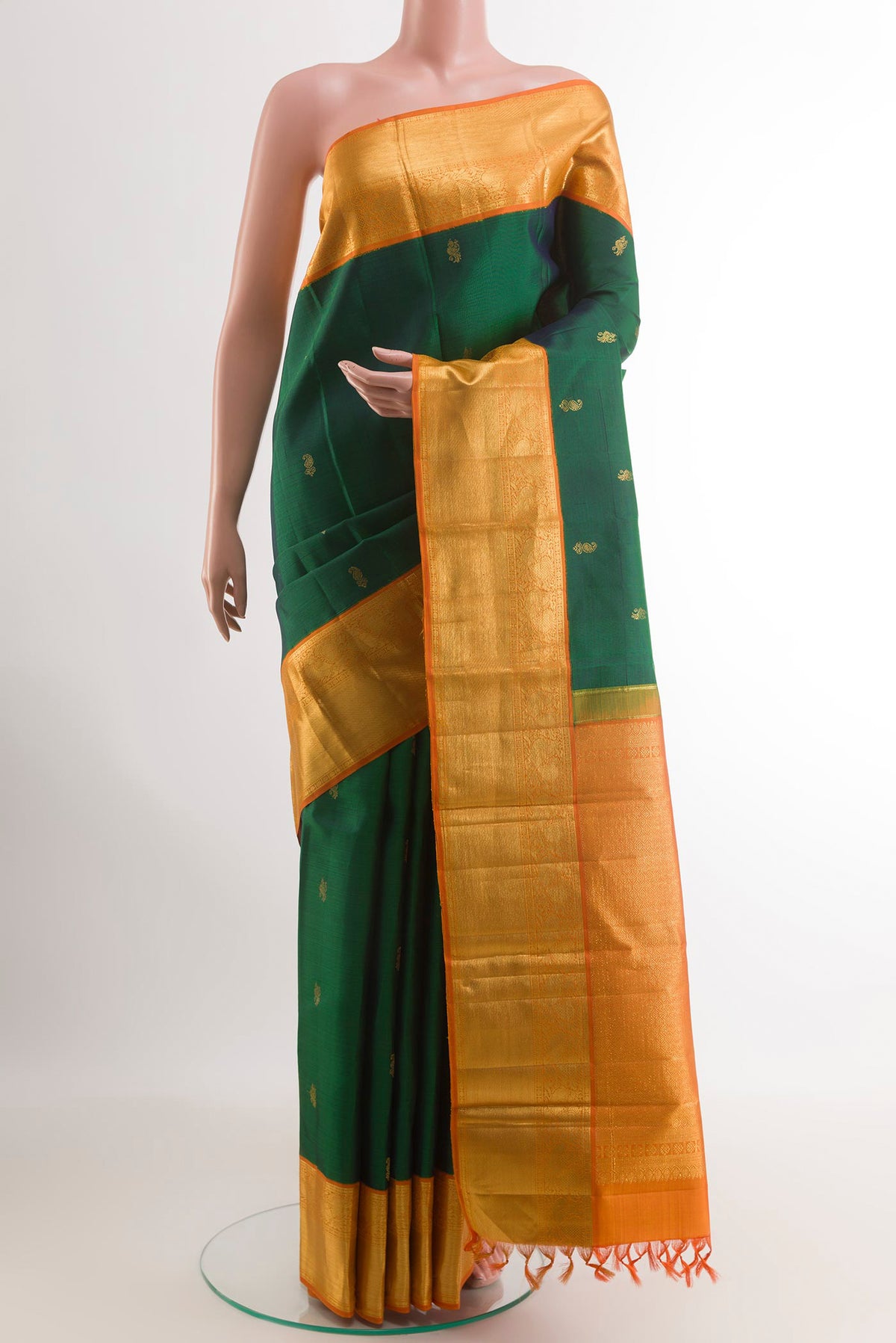 Bottle Green Kanjivaram Silk Saree with Zari Butta on the body and Zari Border.  displayed on a mannequin