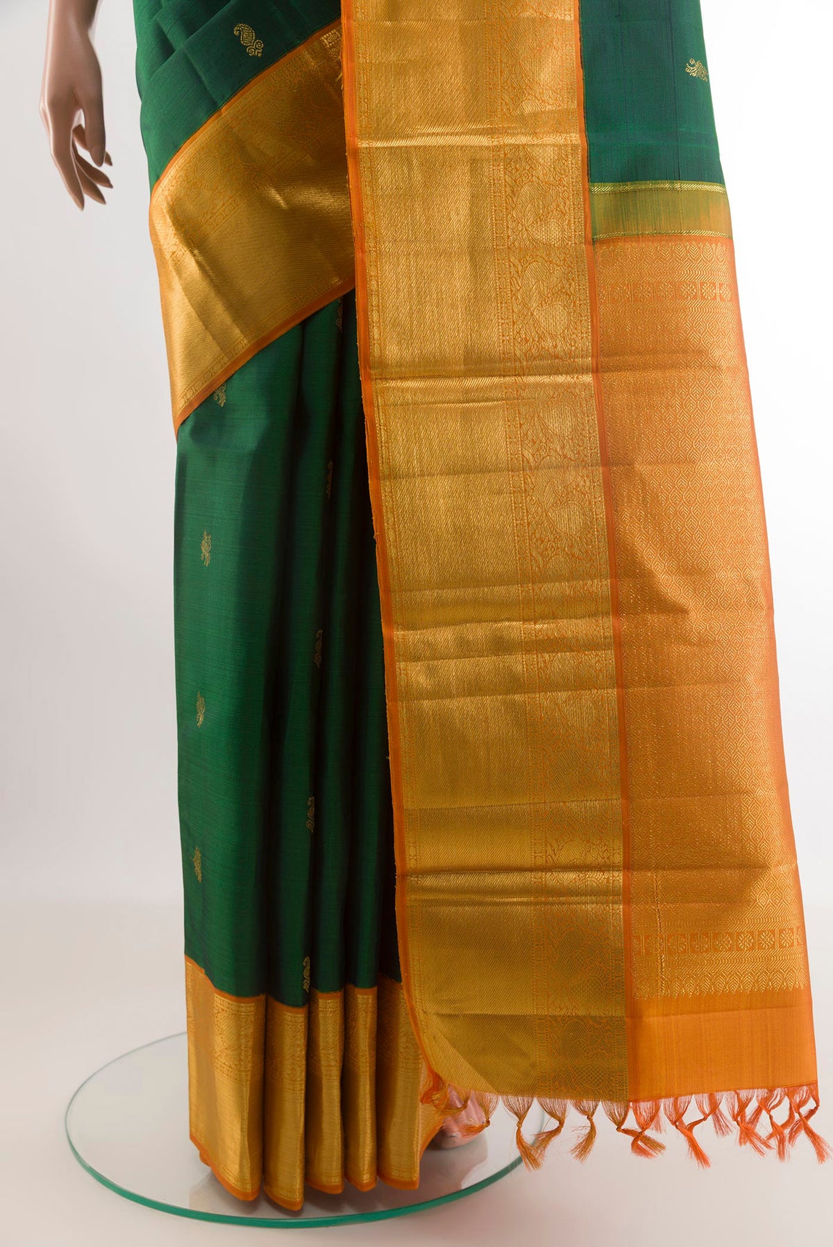 Pleats and pallu of Bottle Green Kanjivaram Silk Saree with Zari Butta on the body and Zari Border. 