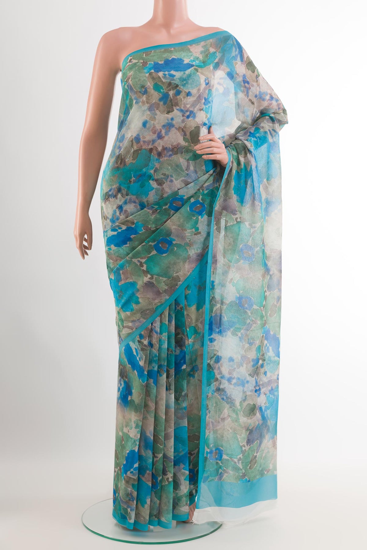 Blue Chiffon Saree with Printed design on the body and Plain Border.  displayed on a mannequin