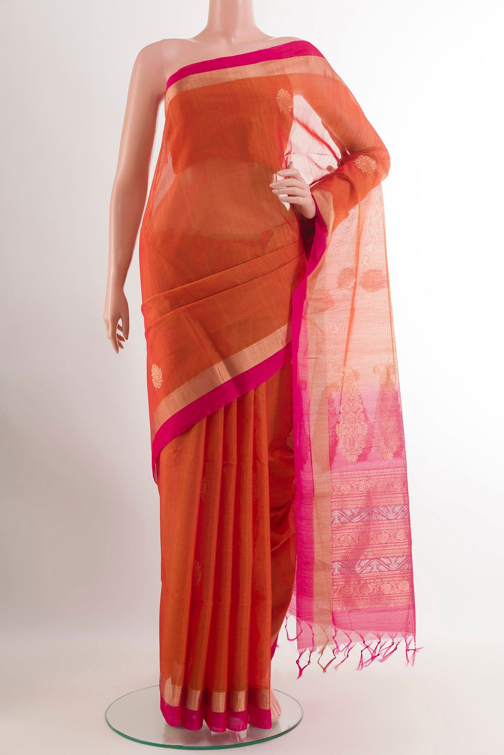 Orange Blended Kora Cotton Saree with Zari Butta on the body and Zari Border.  displayed on a mannequin