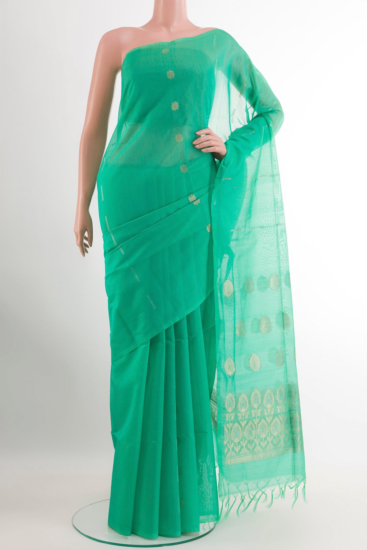 Green Silk Cotton Saree with Zari Butta on the body and Without Border.  displayed on a mannequin