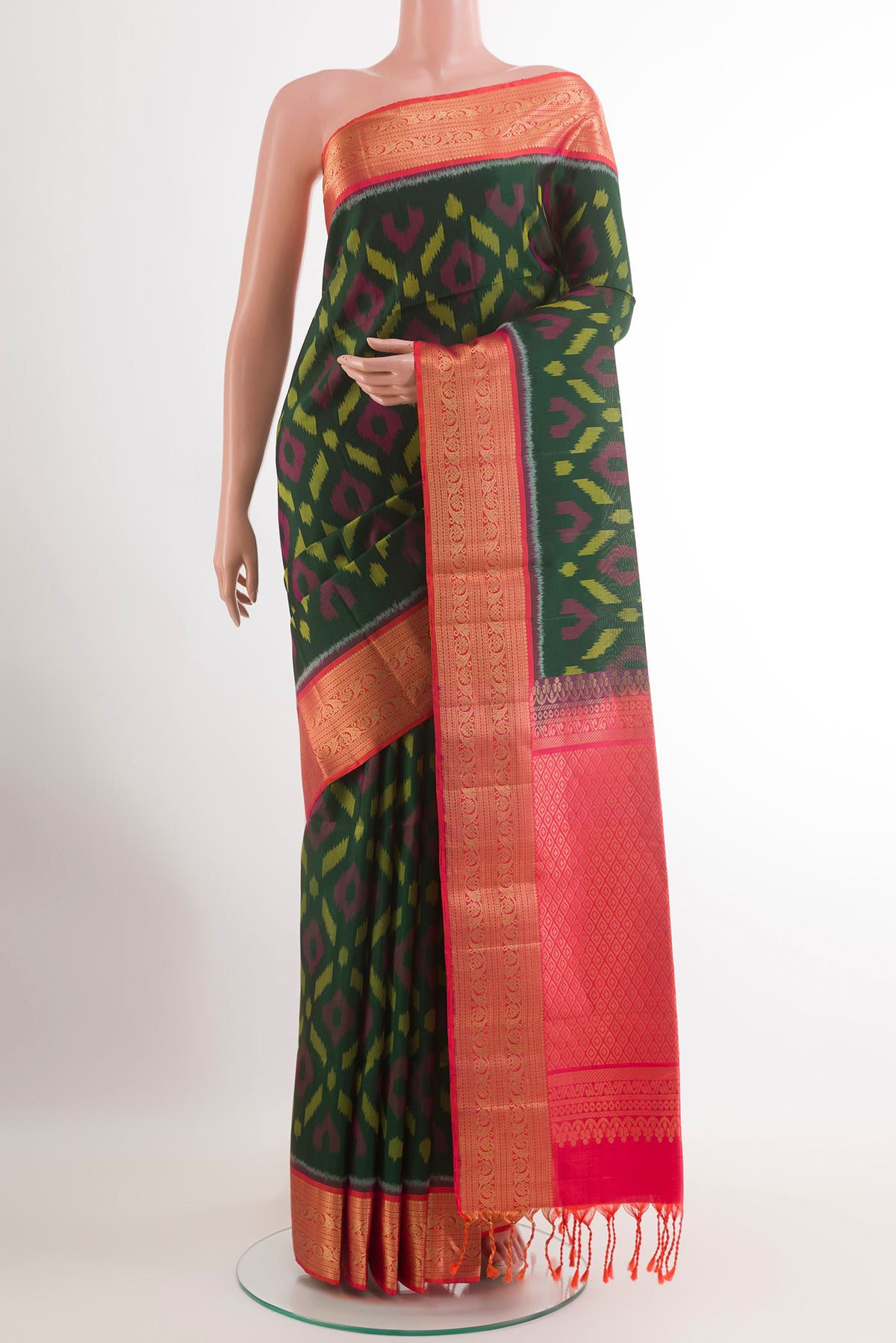 Bottle Green Soft Silk Saree with Ikat design on the body and Zari Border.  displayed on a mannequin