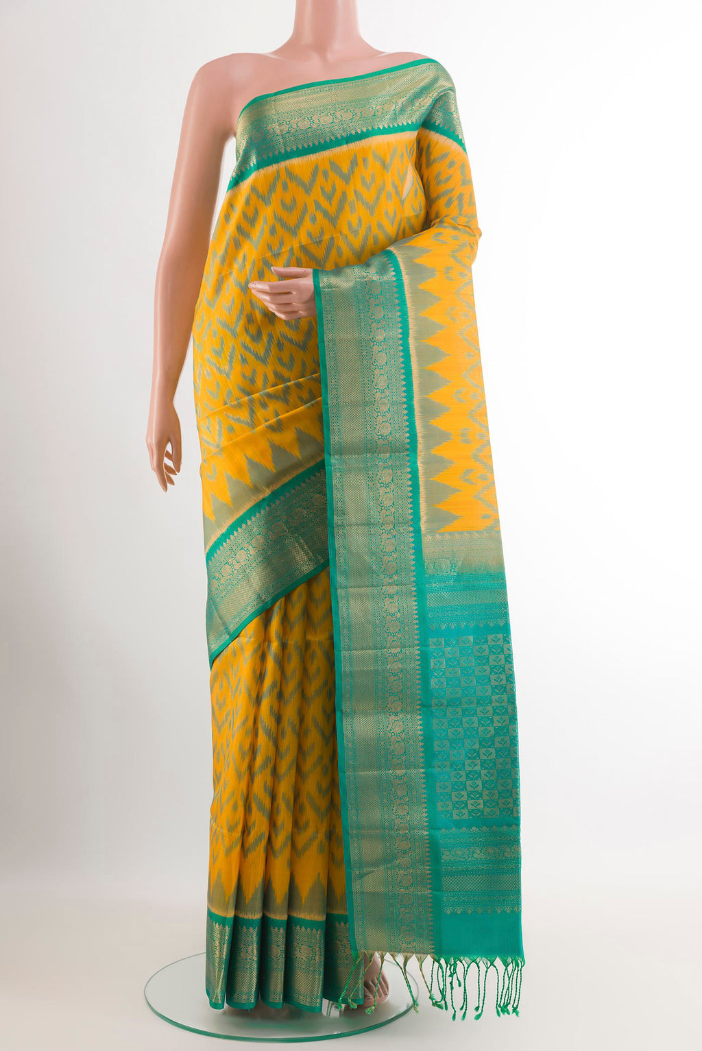 Yellow Soft Silk Saree with Ikat design on the body and Zari Border.  displayed on a mannequin