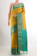Yellow Soft Silk Saree with Ikat design on the body and Zari Border.  displayed on a mannequin