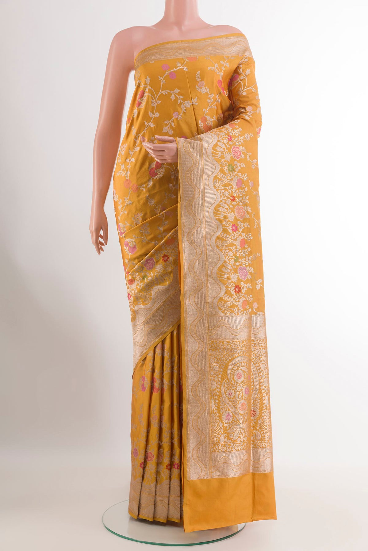 Mustard Banarasi Silk Saree with Zari Butta on the body and Zari Border.  displayed on a mannequin