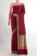 Maroon Banarasi Silk Saree with Zari Butta on the body and Zari Border.  displayed on a mannequin