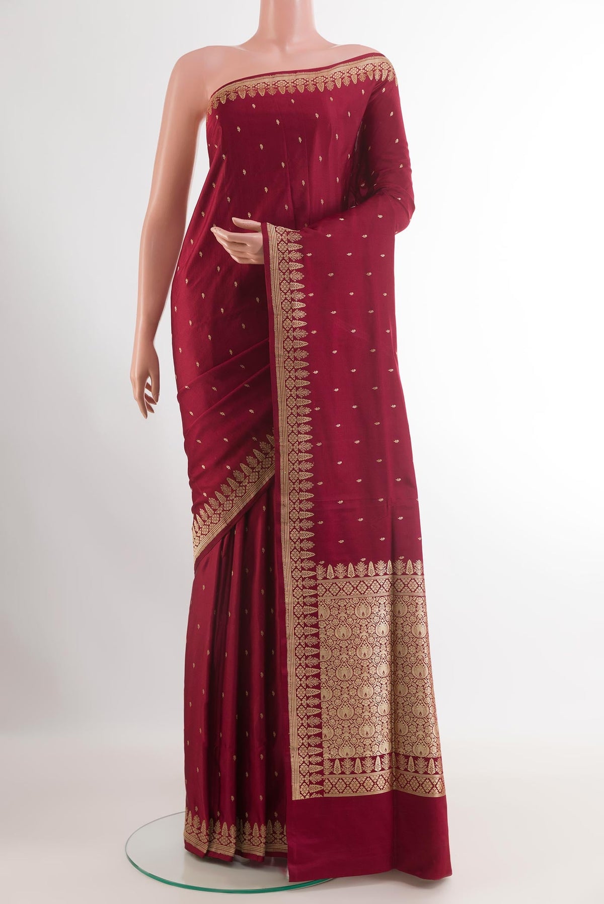 Maroon Banarasi Silk Saree with Zari Butta on the body and Zari Border.  displayed on a mannequin
