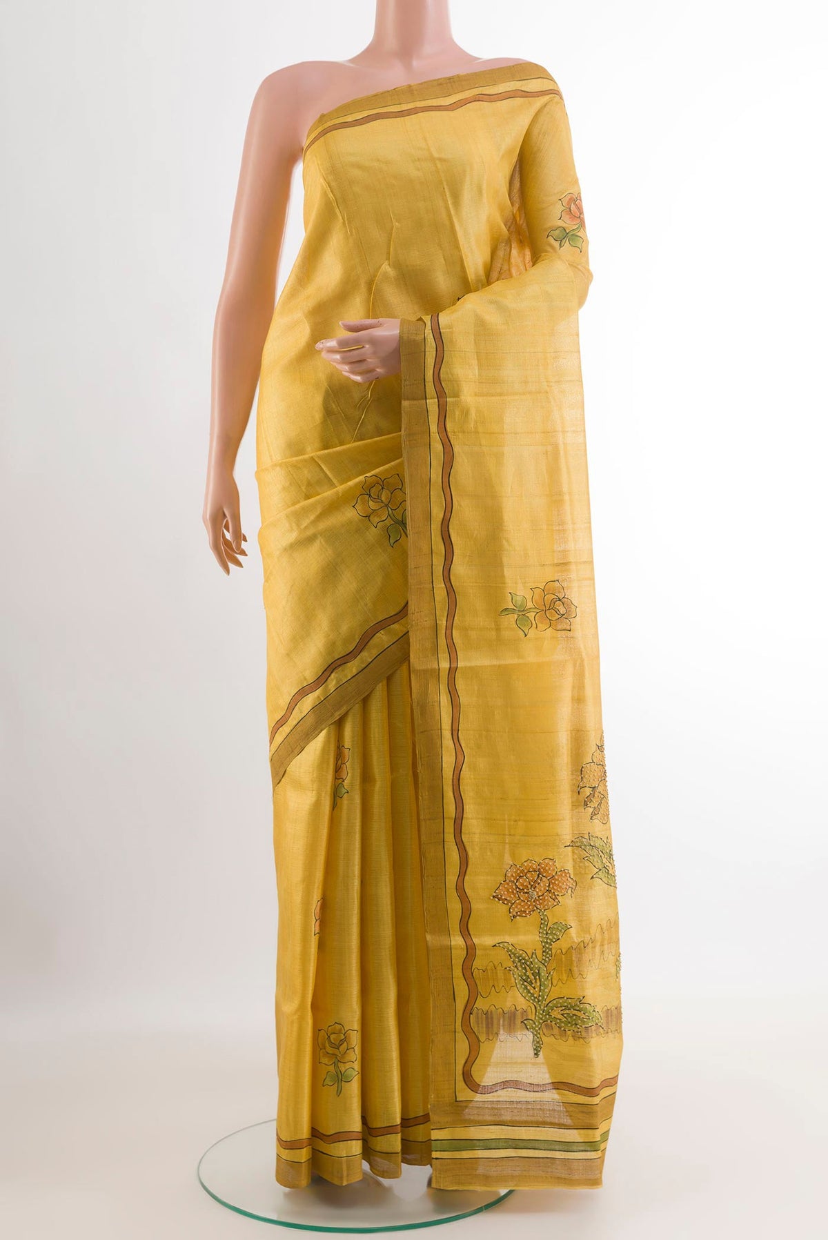 Yellow Tussar Saree with Printed design on the body and Printed Border.  displayed on a mannequin