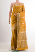 Mustard Tussar Silk Saree with Zari Butta on the body and Zari Border.  displayed on a mannequin
