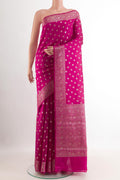 Pink Tussar Silk Saree with Zari Butta on the body and Zari Border.  displayed on a mannequin