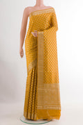 Yellow Tussar Silk Saree with Zari Butta on the body and Zari Border.  displayed on a mannequin