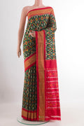 Green Pochampally Silk Saree with Pure Ikat on the body and Zari Border.  displayed on a mannequin