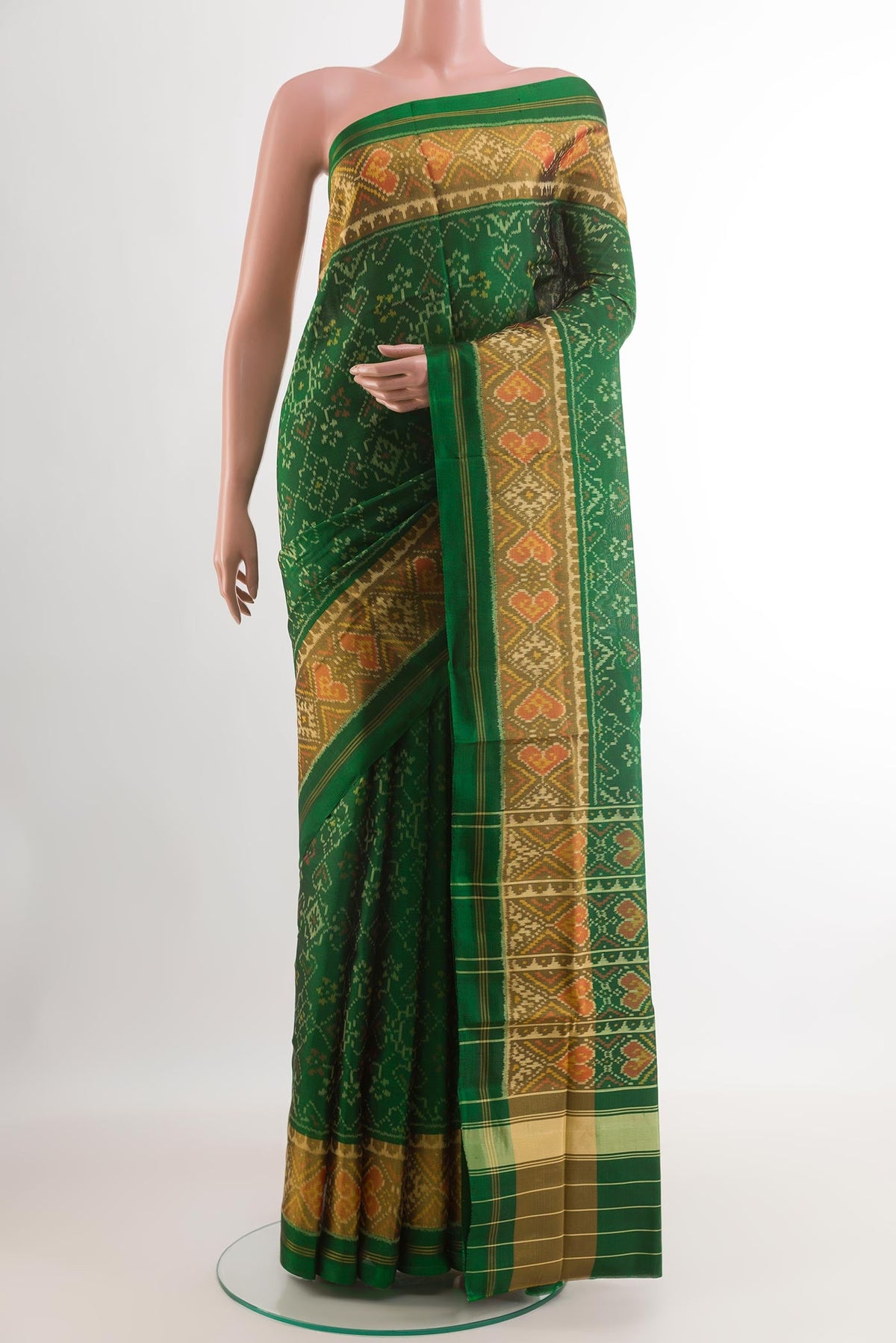 Green Rajkot Patola Silk Saree with Ikat design on the body and Zari Border.  displayed on a mannequin